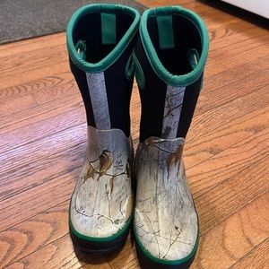 All weather/snow boots. Camo with green and black upper. Size 3